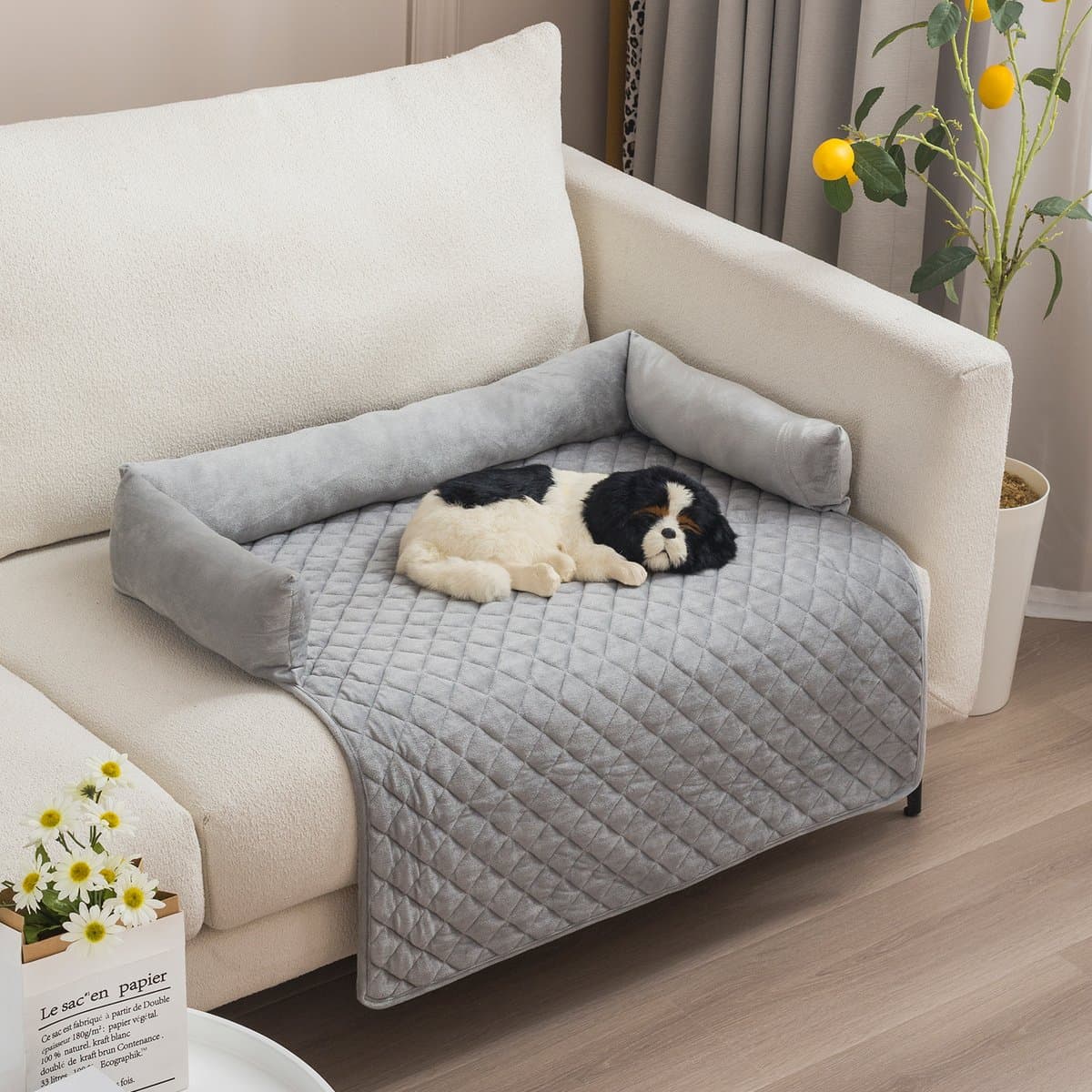 Quilted couch protector with bolsters in Light Gray on a sofa